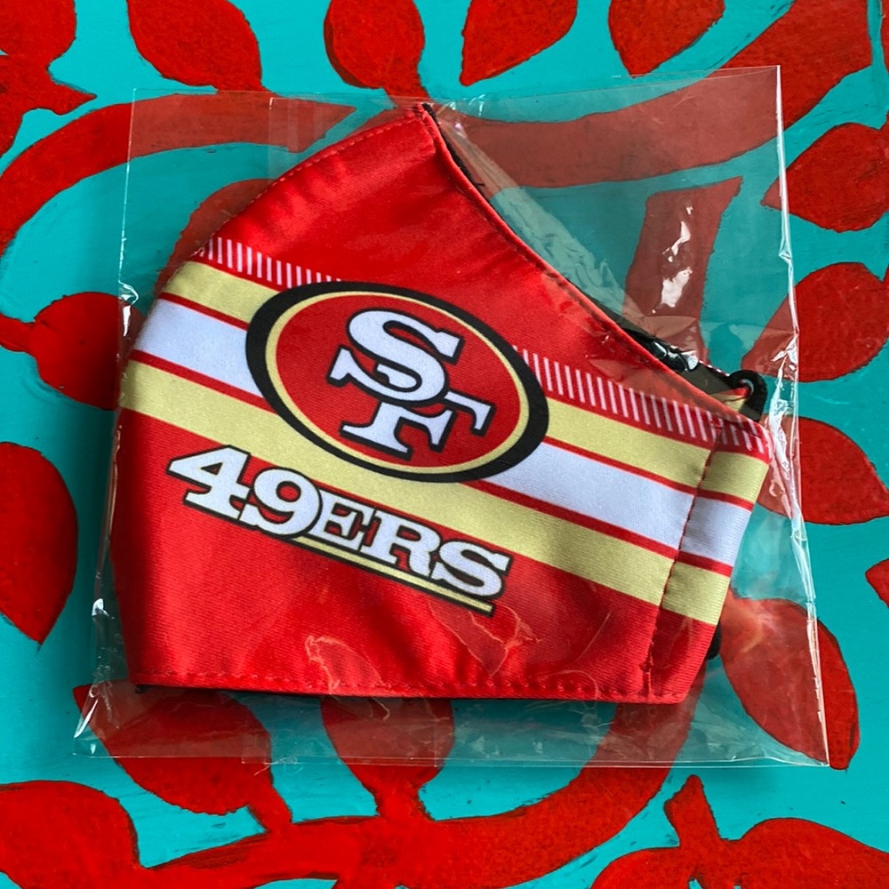 Red and white mask with SF 49ers sign on it